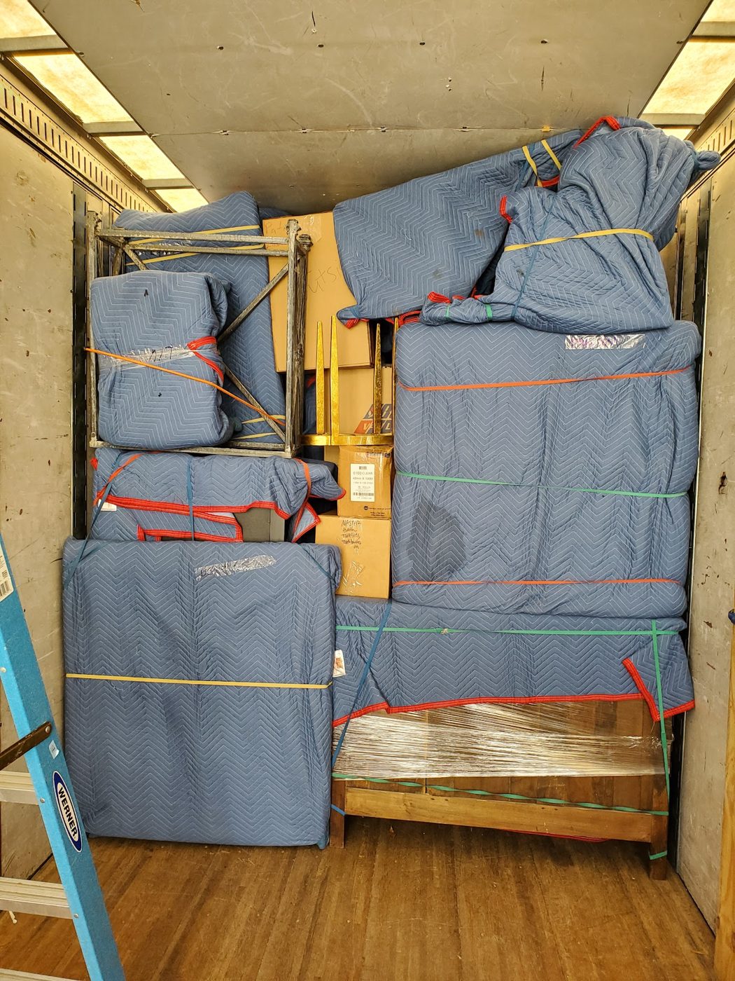 Furniture wrapped in moving blankets